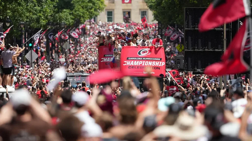 Carolina Hurricanes celebrate in the streets as coach Rod Brind'Amour removes his shirt at the Stanley Cup parade