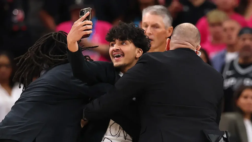 Fan jumps onto the court attempting to take a selfie with Wembanyama during Knicks victory