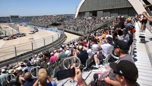 Fan jumps over fence during halted NASCAR race at San Diego's Naval Base Coronado to approach a driver