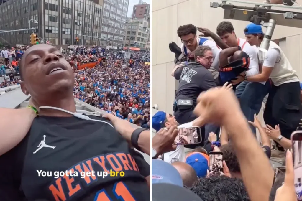 Fans help a person in distress during the championship parade.