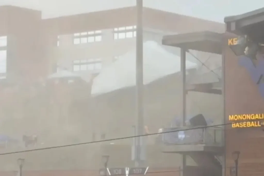 Five injured as strong winds sweep through a WVU baseball game, lifting tents into the air.