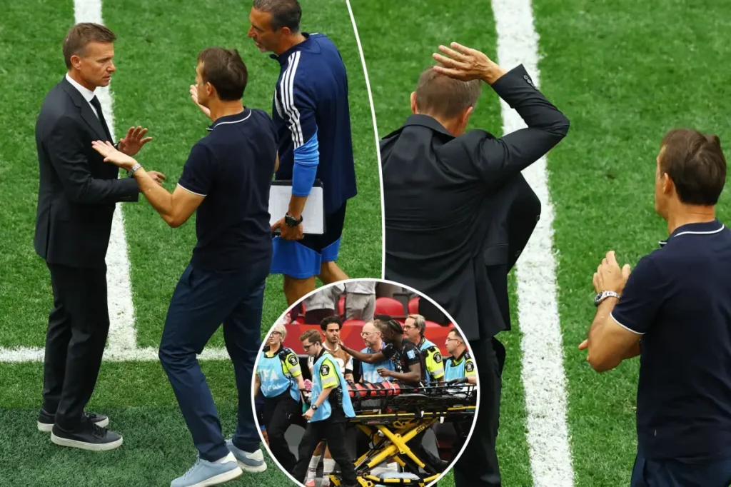 Jesse Marsch from Canada gestures to the Qatar coach after serious World Cup injury