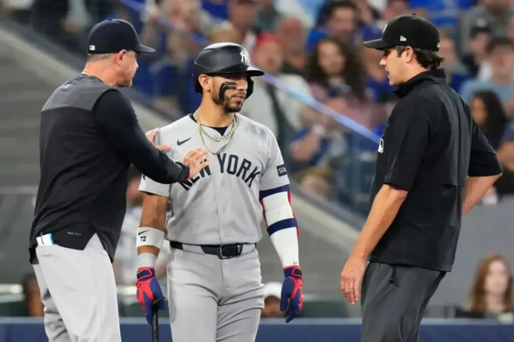 Jose Caballero of the Yankees asks for clarity on pitch clock rules following a tense exchange with an umpire.