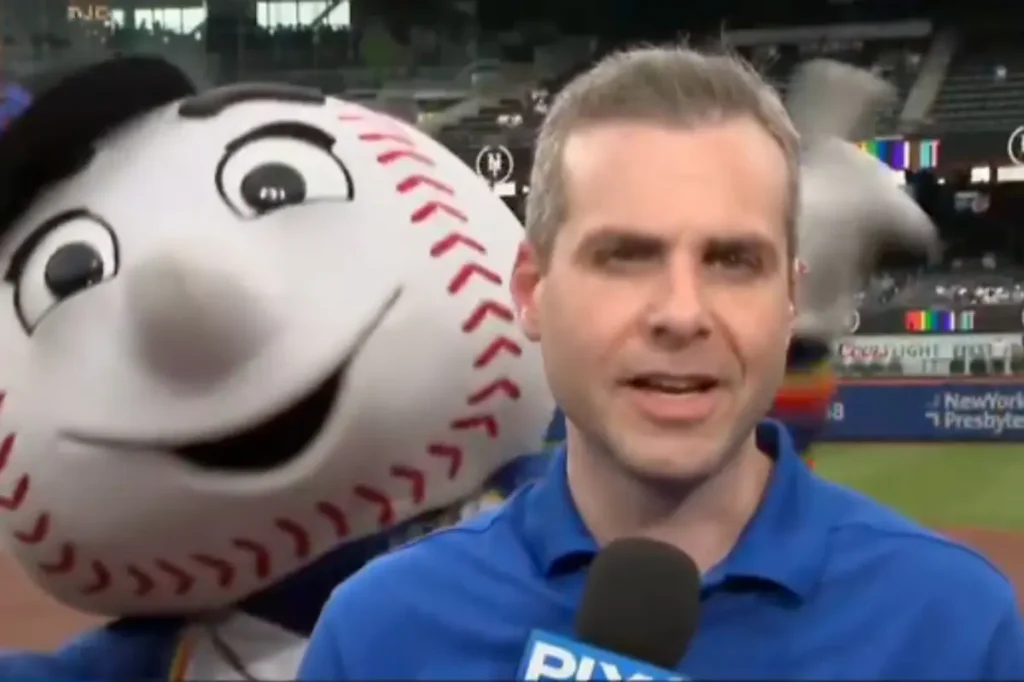 Mr. Met dances behind Steve Gelbs during a segment with Carlos Mendoza