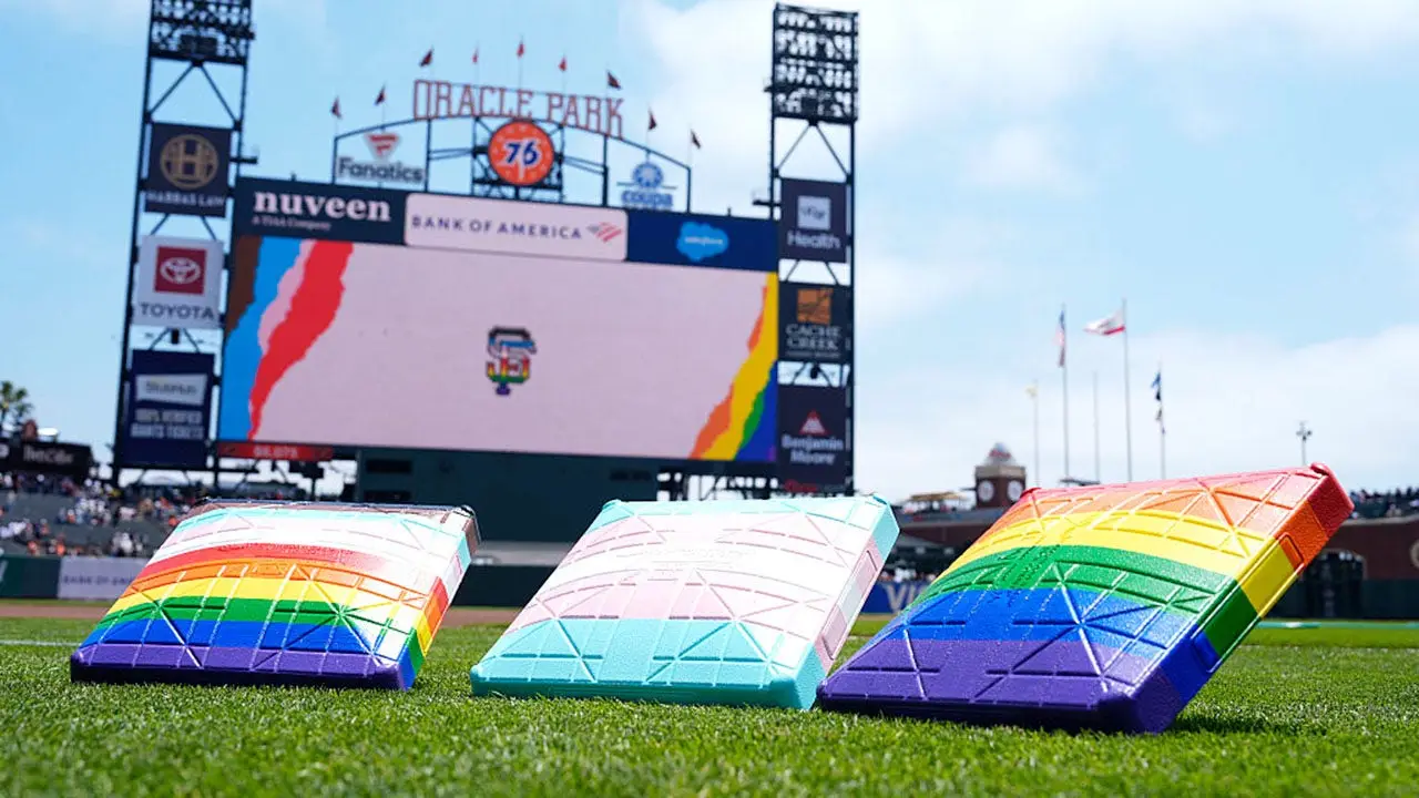 San Francisco Giants welcome same-sex couples renewing their vows with a drag queen during a Pride Night event.