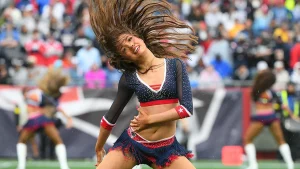 Scottish fan reacts excitedly upon encountering New England Patriots cheerleaders at World Cup match