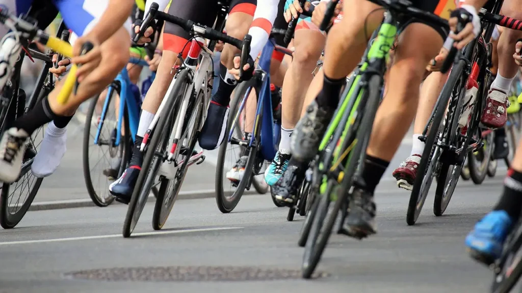 Senior fan on a mobility scooter causes cyclists to crash during a race by entering the course