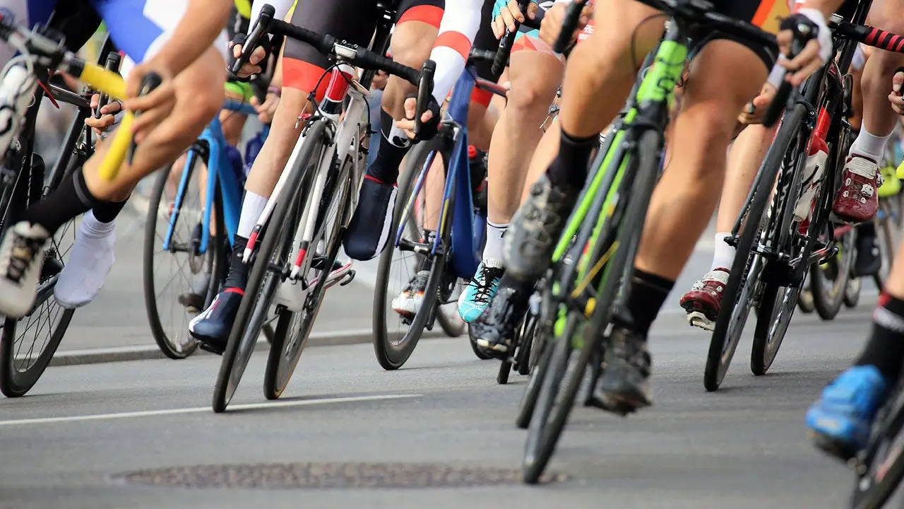 Senior fan on a mobility scooter causes cyclists to crash during a race by entering the course