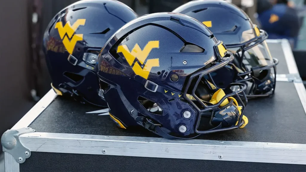 West Virginia recruit reveals choice by playing 'Country Roads' and setting a couch on fire.