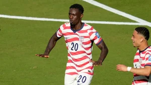 Folarin Balogun scores and performs the LeBron James silencer gesture in celebration