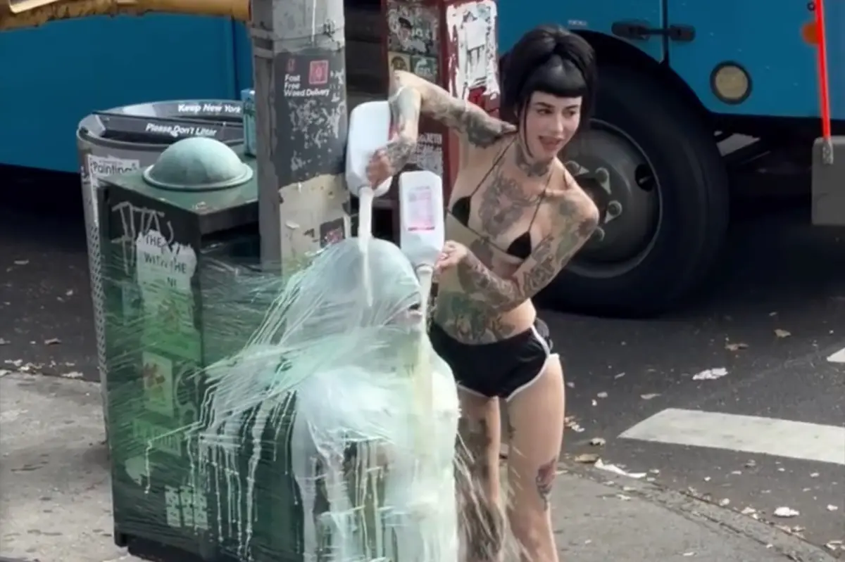 NYC dominatrix wraps her submissive in plastic and pours milk on him