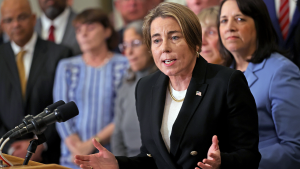 Woman manages Massachusetts booth after governor withdraws from Great American State Fair.