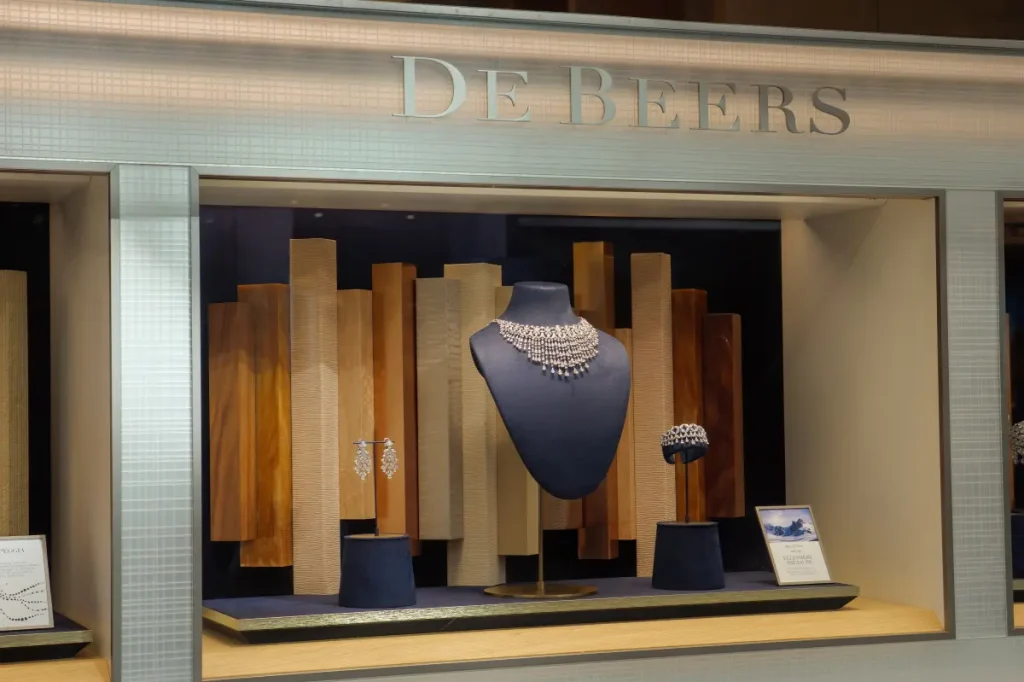 De Beers in discussions to sell for $1B to a group, significantly less than its previous value due to falling demand.