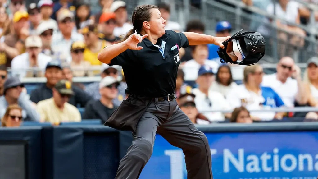 Female umpire causes frustration with strange calls, NASCAR spouse enjoys the beach, and Aaron Rodgers makes an appearance.