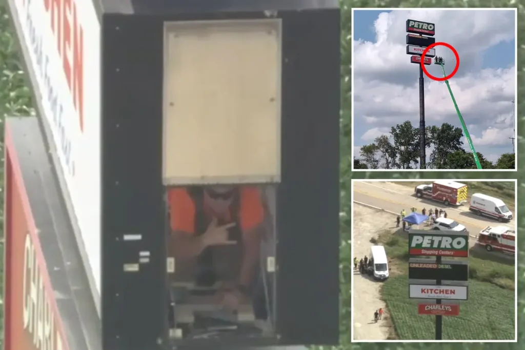 Maintenance worker stuck in a 130-foot-tall gas station sign in Illinois but still manages to give a thumbs up