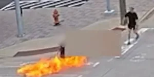 Man in wheelchair set on fire by attacker with a Molotov cocktail in front of police headquarters