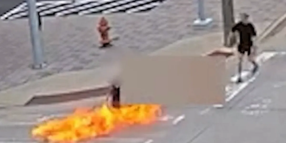 Man in wheelchair set on fire by attacker with a Molotov cocktail in front of police headquarters