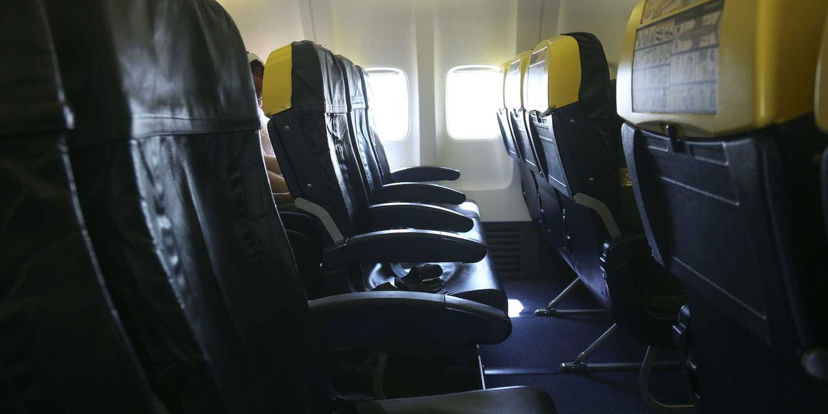 Passenger partly ejected from window during flight — his wife and others held onto him
