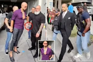 Video of Andrew Tate's arrest captures the moment he attempted to hand his phone to his bodyguard while being restrained by US Marshals.