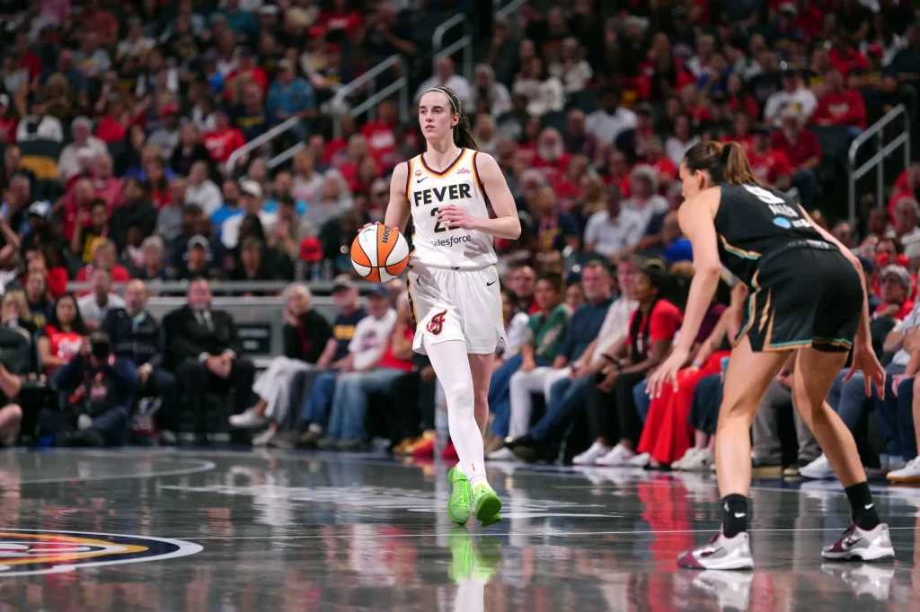 Caitlin Clark and Kelsey Mitchell lead the Fever to victory over the Liberty, placing Indiana at the top of the Eastern Conference.