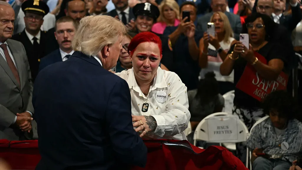 Donald Trump leaves the stage after his speech to embrace the grieving parents of Jacob Freytes.