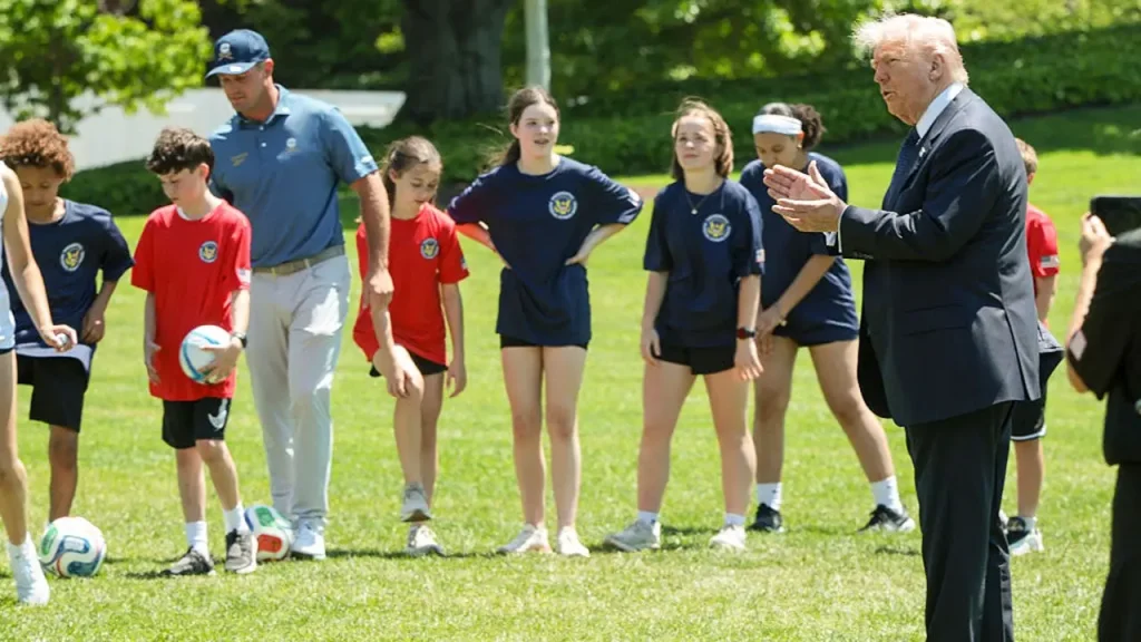 Pat McAfee shows up at a sports event with President Trump dressed in jeans and a backward cap