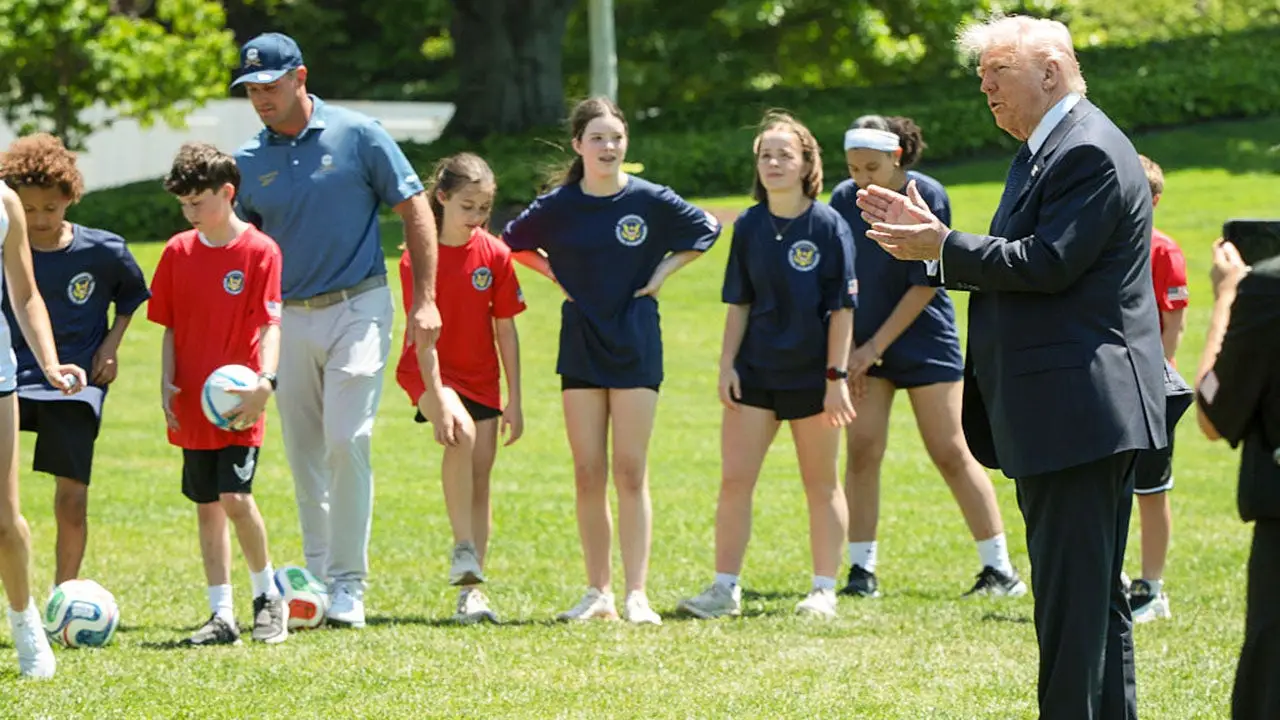 Pat McAfee shows up at a sports event with President Trump dressed in jeans and a backward cap