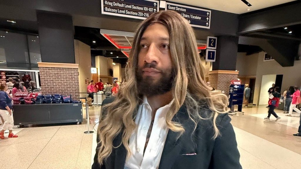 Royce White appears at an Indiana Fever game wearing a blonde wig while aiming for a spot in the WNBA Draft.