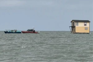 Fisherman sees a two-story house being pulled across San Pablo Bay