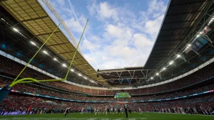 Football field specialist describes playing an international game on a Brazilian field as 'difficult' and mentioned the need for trimming with scissors.
