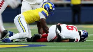 Giants quarterback Jaxson Dart experiences knee injury in game against Rams, potential MCL concern anticipated