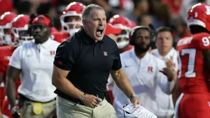 Greg Schiano of Rutgers is ejected after a significant penalty in a difficult defeat to USC