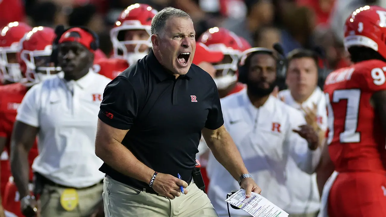Greg Schiano of Rutgers is ejected after a significant penalty in a difficult defeat to USC