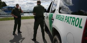 Demonstrators assist 2 migrants in fleeing from Border Patrol after a lengthy standoff atop a roof in New York
