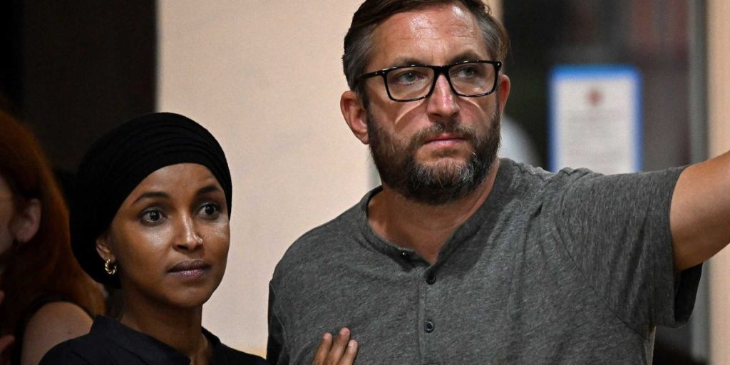 Ilhan Omar's spouse angrily responds to reporter's questions following home search.