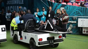NFL line judge kneels and seems to pray after umpire collapses during Jaguars-Texans game in London.