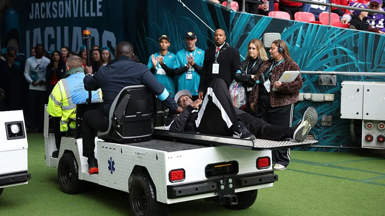 NFL line judge kneels and seems to pray after umpire collapses during Jaguars-Texans game in London.