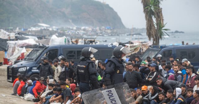 Spanish police start to remove unauthorized migrants from the beach camp in Ceuta.