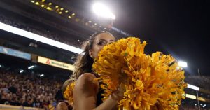 Video shows Arizona State cheerleader pushed to the ground and struck by police during an arrest.