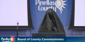 Woman in a Muslim burqa speaks at a public meeting in Florida, and her next action leads to her removal.