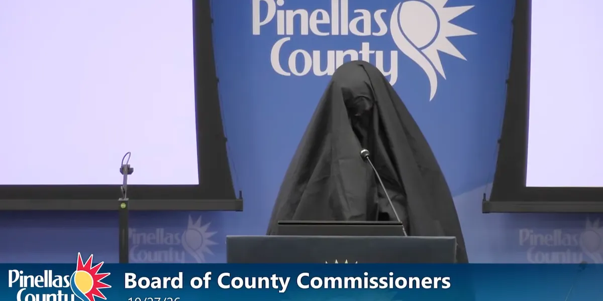 Woman in a Muslim burqa speaks at a public meeting in Florida, and her next action leads to her removal.
